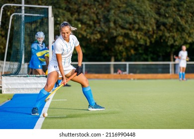 Young Woman Performing Penalty Shot In Field Hockey Game.