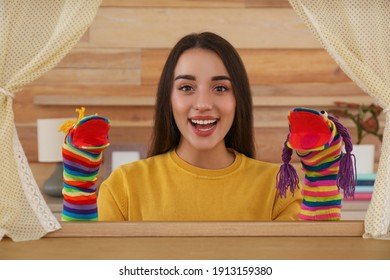 Young Woman Performing Puppet Show At Home