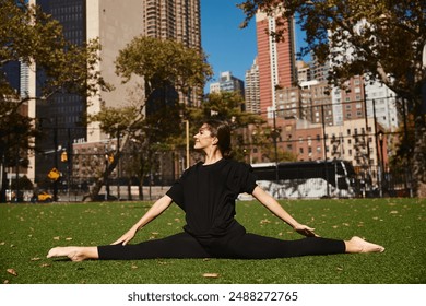 A young woman performs a split on a grassy park in the heart of New York City. - Powered by Shutterstock