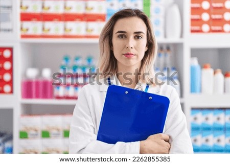 Young woman pharmacist holding checklist at pharmacy Photo stock © 