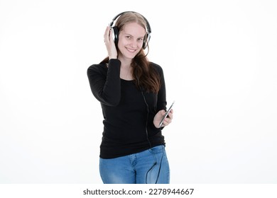 young woman phone in hand listening to music with smartphone headphones - Shutterstock ID 2278944667