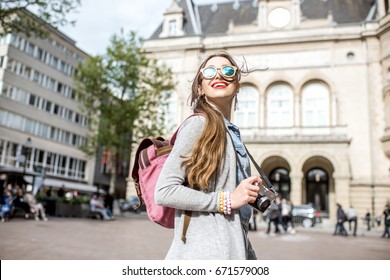 Young woman with photocamera traveling at the old town of Luxembourg city