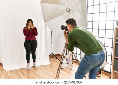 Young Woman At Photography Studio Shocked Covering Mouth With Hands For Mistake. Secret Concept. 