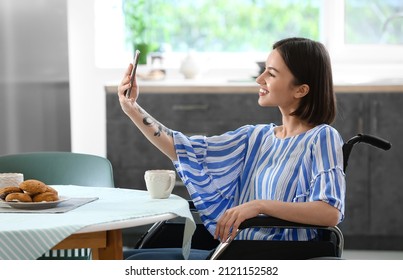 Young Woman With Physical Disability Taking Selfie In Kitchen