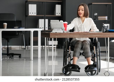 Young Woman With Physical Disability Working In Office