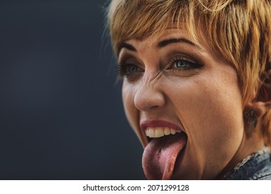 Young Woman With Piercing Sticking Out Her Tongue To Show The Hole With No Stud Or Jewellery Present