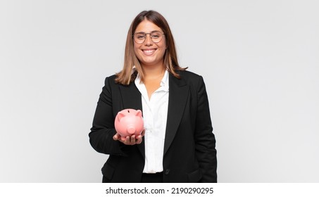 Young Woman With A Piggy Bank Looking Happy And Pleasantly Surprised, Excited With A Fascinated And Shocked Expression