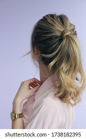 Young Woman In A Pink Lapel Collar Short Sleeve Shirt With A Messy Twisted Balayage Ponytail And Golden Accessories Back View Photo