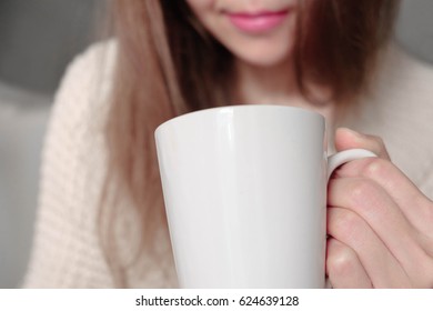 young woman with pink lips holding a white cup, closeup - Shutterstock ID 624639128