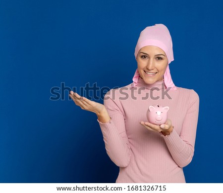 Young woman with pink scarf on the head on a blue background