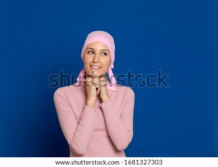 Young woman with pink scarf on the head on a blue background