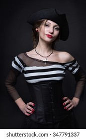 Young Woman In A Pirate Costume And Hat On Black Background. 