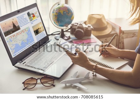 Young woman planning vacation trip and searching information or booking an hotel on a smart phone and laptop, Travel plan concept
