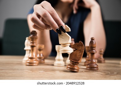 Young Woman Playing Chess Alone