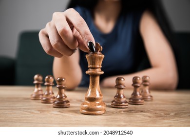 Young Woman Playing Chess Alone