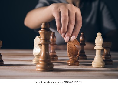 Young Woman Playing Chess Alone