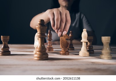 Young Woman Playing Chess Alone