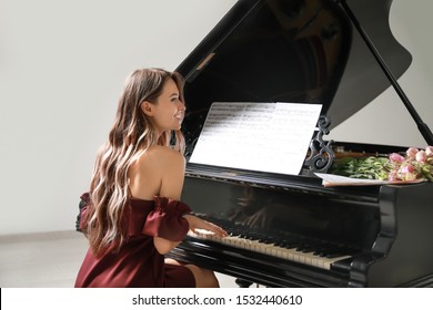 Young Woman Playing Grand Piano At The Concert