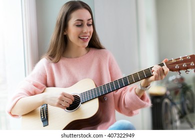 Young Woman Playing Guitar
