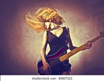 Young Woman Playing The Guitar