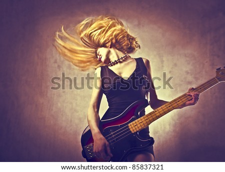 Young woman playing the guitar