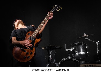 Young Woman Playing Guitar During The Concert