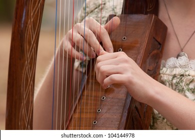 Young Woman Playing A Harp