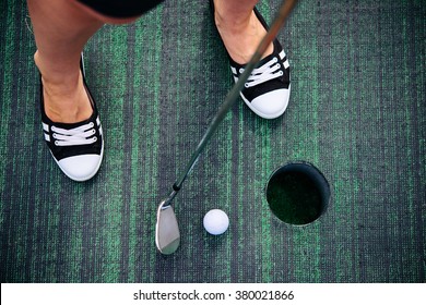 Young Woman Is Playing Mini Golf. Selective Focus