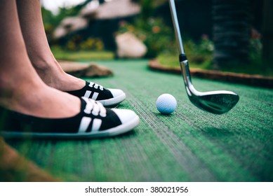 Young Woman Is Playing Mini Golf. Selective Focus