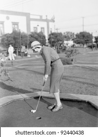 Young Woman Playing Mini Golf