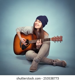 Young Woman Playing Music On Acoustic Guitar, Toned