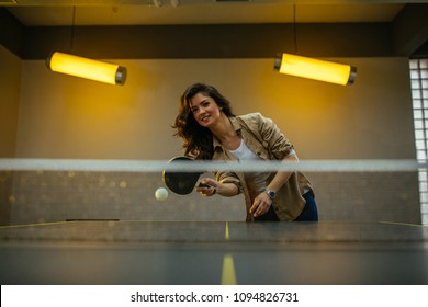 Young Woman Playing Table Tennis