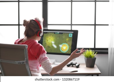 Young Woman Playing Video Game At Home