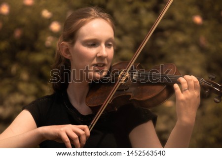 A young woman playing the violin
