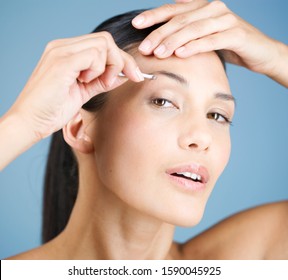 A Young Woman Plucking Her Eyebrows