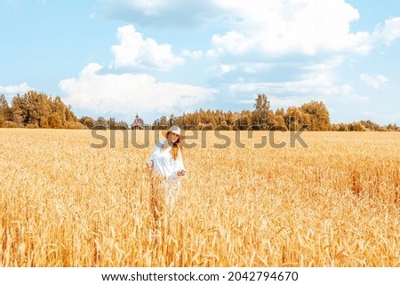 Similar – Woman alone in a field of wheat