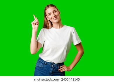 Young Woman Pointing Up Against Green Background - Powered by Shutterstock