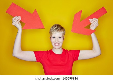 Young Woman Pointing With Two Red Arrows To Herself