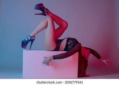 Young Woman Pole Dancer Posing On A Cube In The Style Of Synch Wave