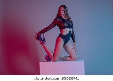 Young Woman Pole Dancer Posing On A Cube In The Style Of Synch Wave