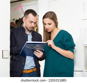 Young woman polling form of marketing research or census of population at her apartment - Shutterstock ID 2205311885