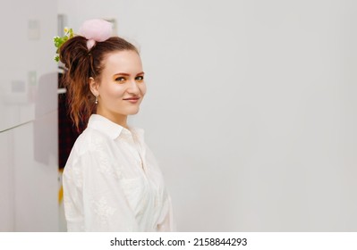 A Young Woman With A Ponytail On Her Head And A Pink Hair Clip. Bright Makeup Presenter For A Children's Holiday.