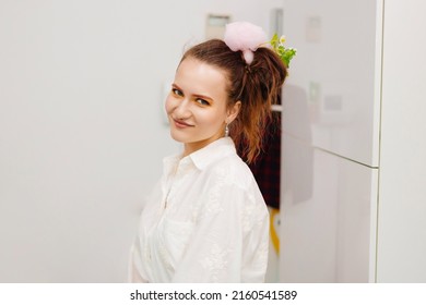 A Young Woman With A Ponytail On Her Head And A Pink Hair Clip. Bright Makeup Presenter For A Children's Holiday.