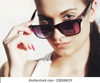 Young Woman Portrait With Sun Glasses And Pony Tail