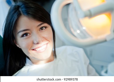 Young Woman Portrait Visiting The Dentist And Smiling