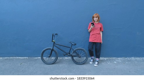 Young woman posing with BMX bicycle outdoor on the street  - Powered by Shutterstock