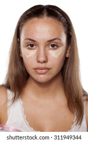 young woman posing with a concealer under the eyes