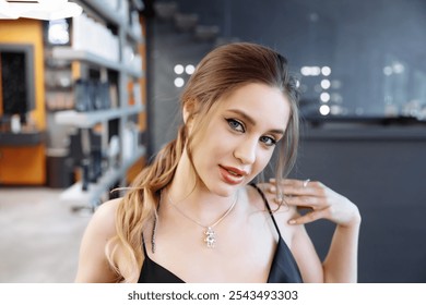 Young woman posing confidently in a modern salon with stylish decor - Powered by Shutterstock