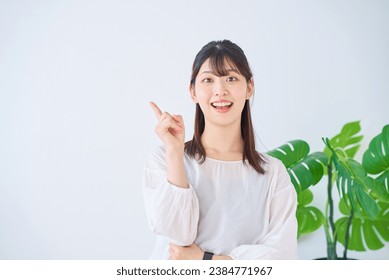 A young woman posing with her index finger raised - Powered by Shutterstock