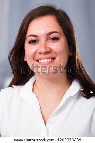 Young woman posing playfully in good humor in free time